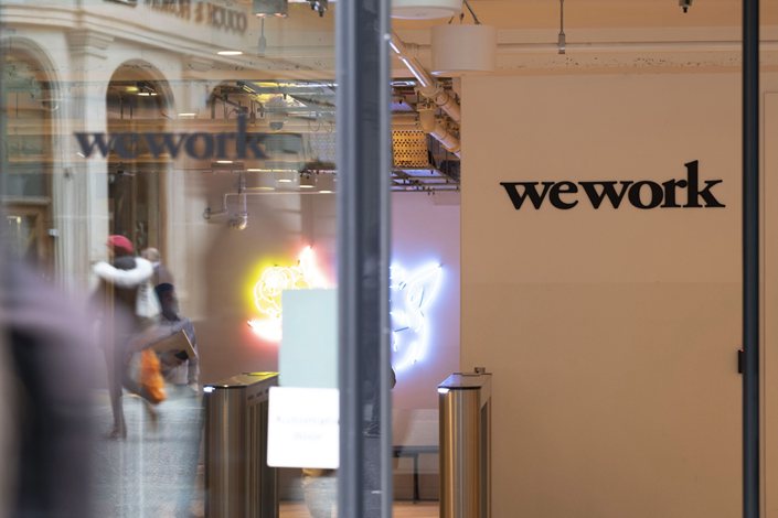 The WeWork logo sits on the entrance to the co-working office space, operated by the parent company We Co., on Eastcheap in London, U.K., on Oct. 7, 2019. Photo: Bloomberg
