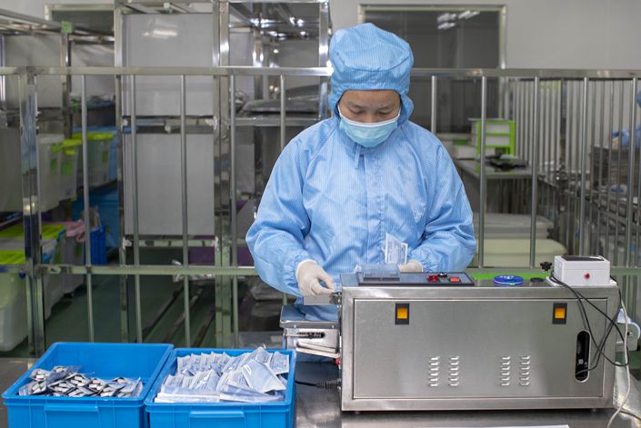 On April 9, a worker packs Covid-19 detection reagents produced by a biotechnology company in Taizhou, Jiangsu province.