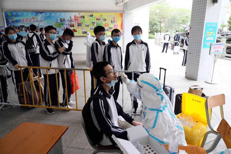 High school students in Zhuhai take virus tests before returning to classrooms April 24.