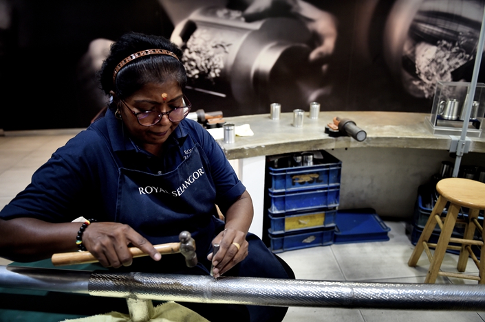 Workers make tinware in Kuala Lumpur, Malaysia, on Aug. 12, 2019.