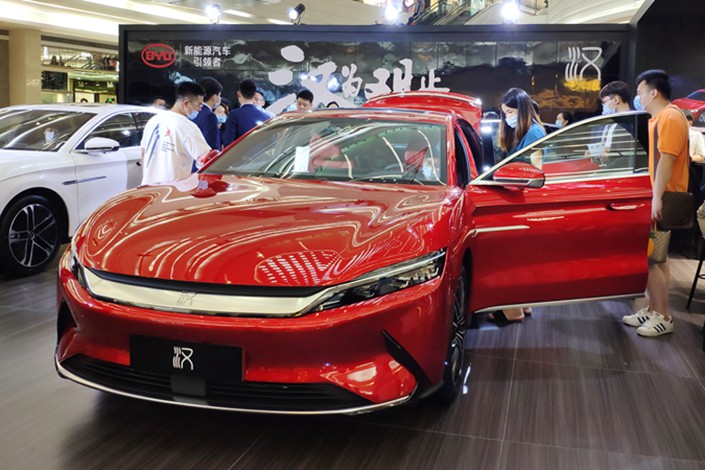 Shoppers check out a BYD electric car at a mall in Shenzhen, South China's Guangdong province, on May 16.