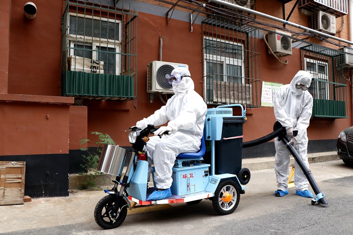 A Beijing residential compound is cleaned on June 17.