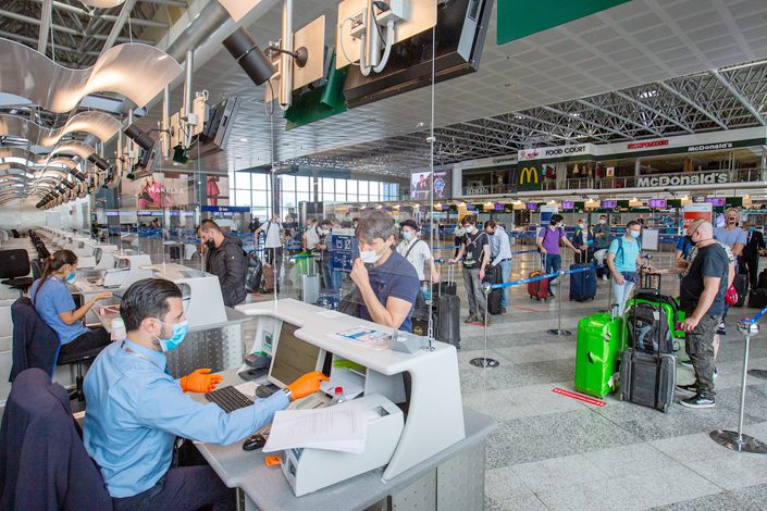 Passengers wait at Milan Malpensa International Airport on June 15.
