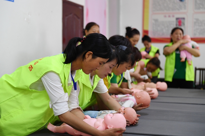Students train to care for infants on June 17 at a vocational school in Renhuai, Southwest China's Guizhou province.