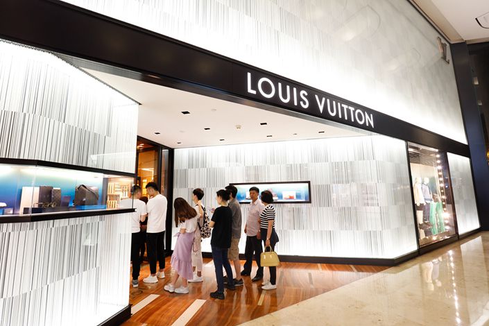 Shoppers line up on April 30 outside a Louis Vuitton store in Nanjing, East China's Jiangsu province.