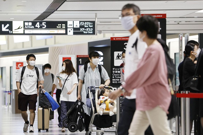 Passengers wearing face masks are pictured at New Chitose Airport in northern Japan on July 22.