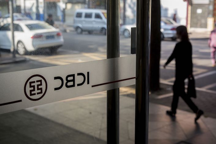 A pedestrian walks past the entrance of a Industrial and Commercial Bank of China Ltd. (ICBC) branch in the Gongbei district of Zhuhai