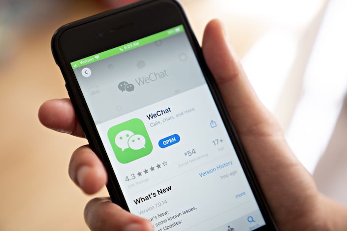 The Tencent Holdings Ltd. WeChat app is displayed in the App Store on a smartphone in an arranged photograph taken in Arlington