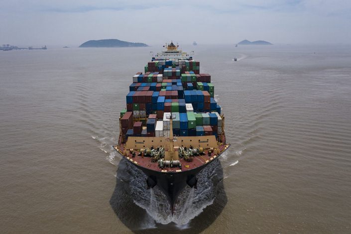 The Kota Cepat vessel loaded with shipping containers approaches the Yangshan Deepwater Port in this aerial photograph taken in Shanghai on July 12. Photo: Bloomberg