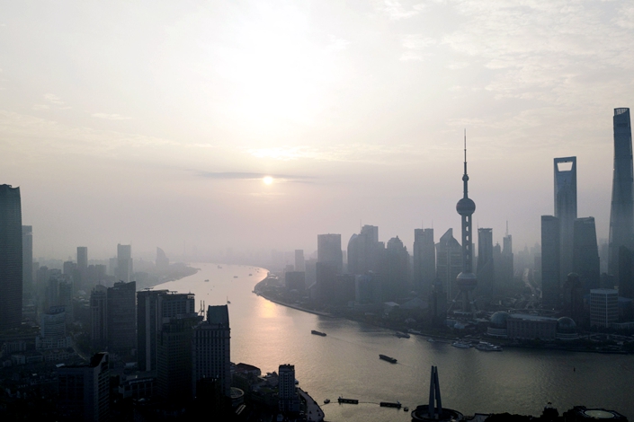 The Shanghai Tower, right, Shanghai World Financial Center, second right, and Oriental Pearl Tower, third right, stand among other buildings in the Lujiazui Financial District along the Pudong riverside in this aerial photograph taken above Shanghai on April 2, 2018.  Photo: Bloomberg
