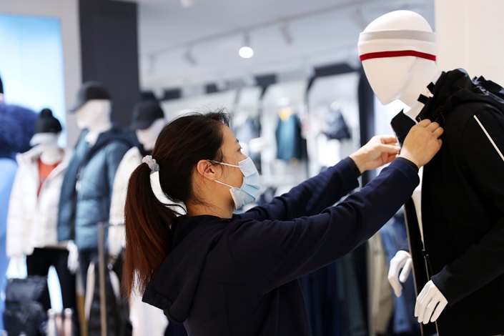 A store employee dresses a mannequin on Nov. 2 at a department store in Urumqi, Northwest China Xinjiang Uygur autonomous region.