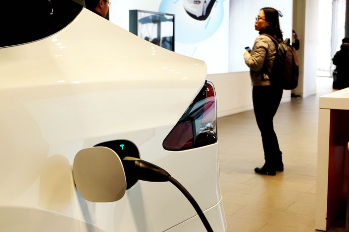 A car is charged at a Tesla showroom in Shanghai.