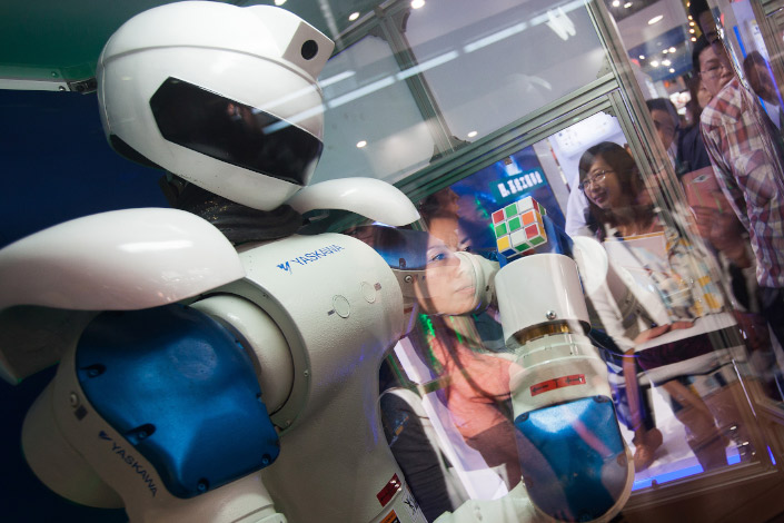 A Yaskawa-manufactured industrial robot stands on display at an exhibition in Shanghai in November 2013.