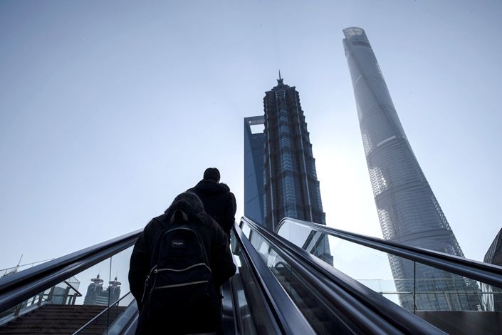 Pedestrians ride on an escalator in Pudong's Lujiazui Financial District in Shanghai on Feb. 18.  Photo: Bloomberg