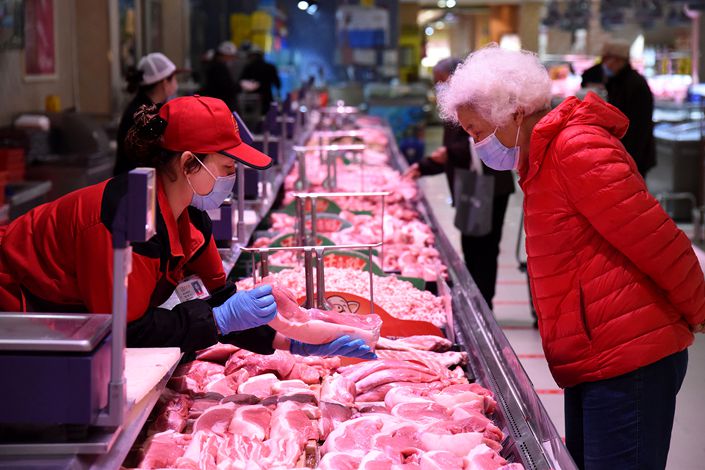 A customer examines the meat on offer Wednesday at a supermarket in Handan, Central China’s Hebei province. Photo: VCG