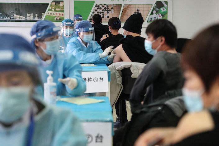 People receive vaccines against the Covid-19 coronavirus at a temporary vaccination centre in Beijing on January 8