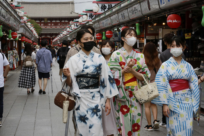 Women wearing masks walk along Asakusa Nakamise shopping street in Tokyo on Friday. Photo: VCG