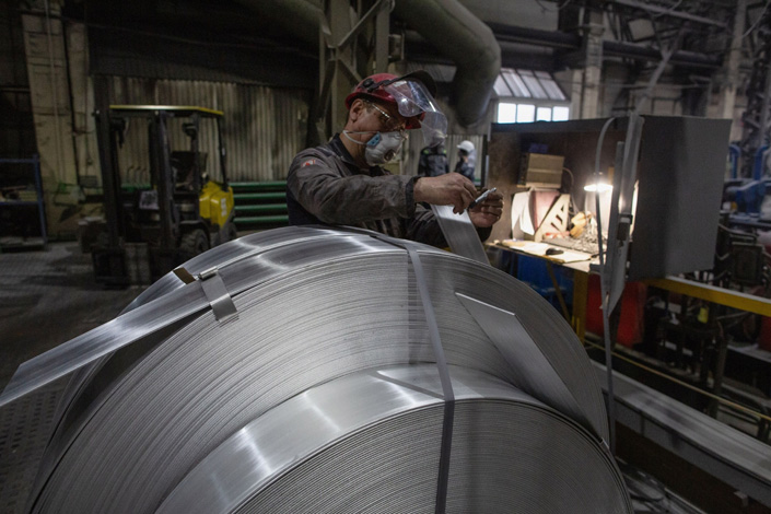 A worker labels rolls of sheet aluminium at the United Co. Rusal aluminium smelting plant in Shelekhov, Russia, on April 9. Photo: Bloomberg