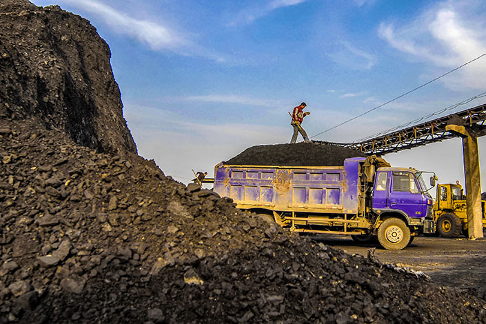 Workers load coal into haul trucks at a coal mine in Xiangyang, Central China’s Hubei province, in 2016. Photo: VCG