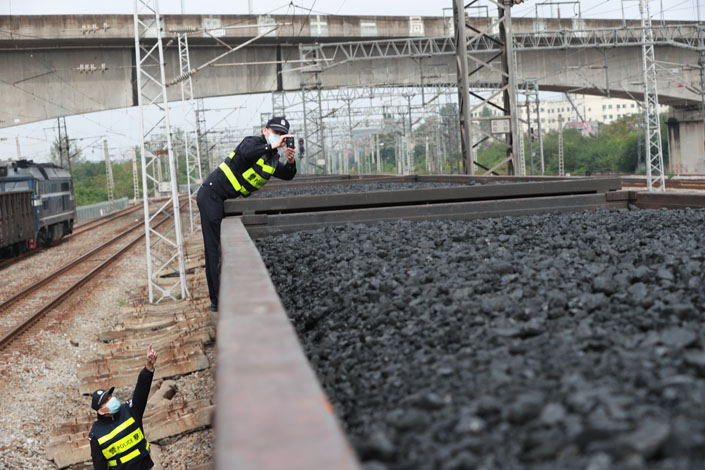 A security officer from the local railway department checks a coal freight train Thursday in Wuhan, North China’s Hubei province. Photo: VCG