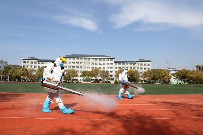 Workers spray disinfectant on the school playground in Northwest China’s Gansu province on Sunday. Photo: VCG