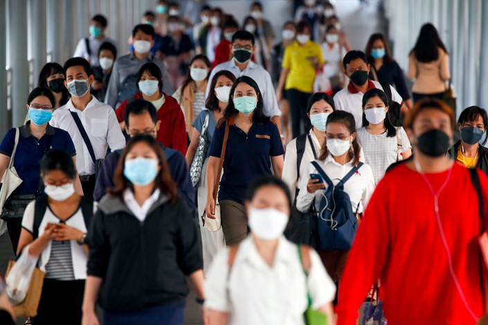 Commuters wear protective masks outside a BTS station in Bangkok, Thailand, 04 November 2021. Photo: IC Photo