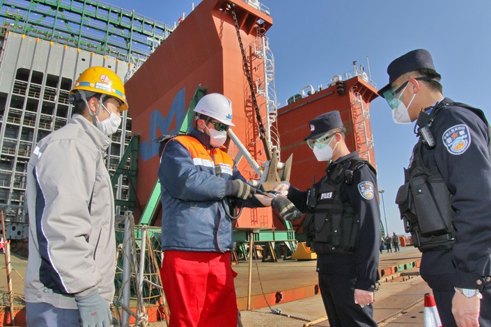 Border police conduct an epidemic prevention inspection at a foreign-funded shipbuilding enterprise in Yantai, Shandong province, on Feb. 26. Photo: VCG