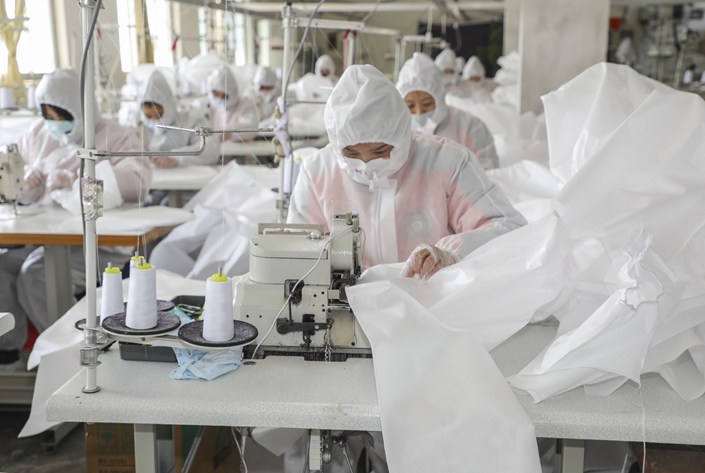 Garment workers manufacture protective clothing in Linyi, Shandong province. Photo: VCG