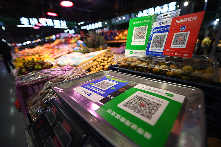 Alipay and WeChat payment codes on a booth in a grocery store. Photo: VCG