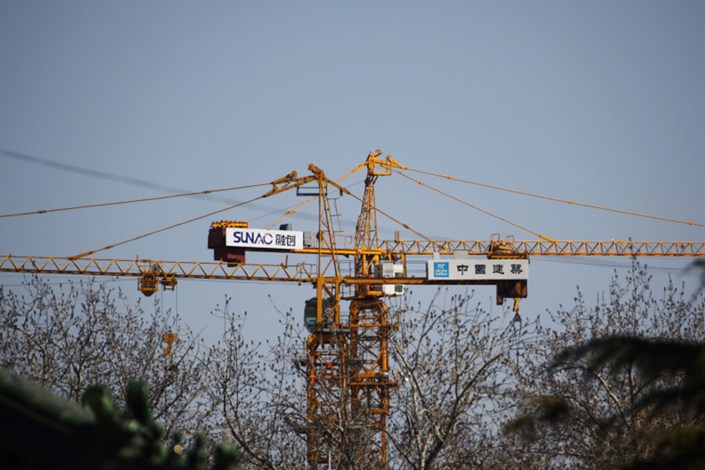Sunac’s logo is displayed on a crane at one of the company's construction sites in Beijing in March 2015. Photo: Bloomberg