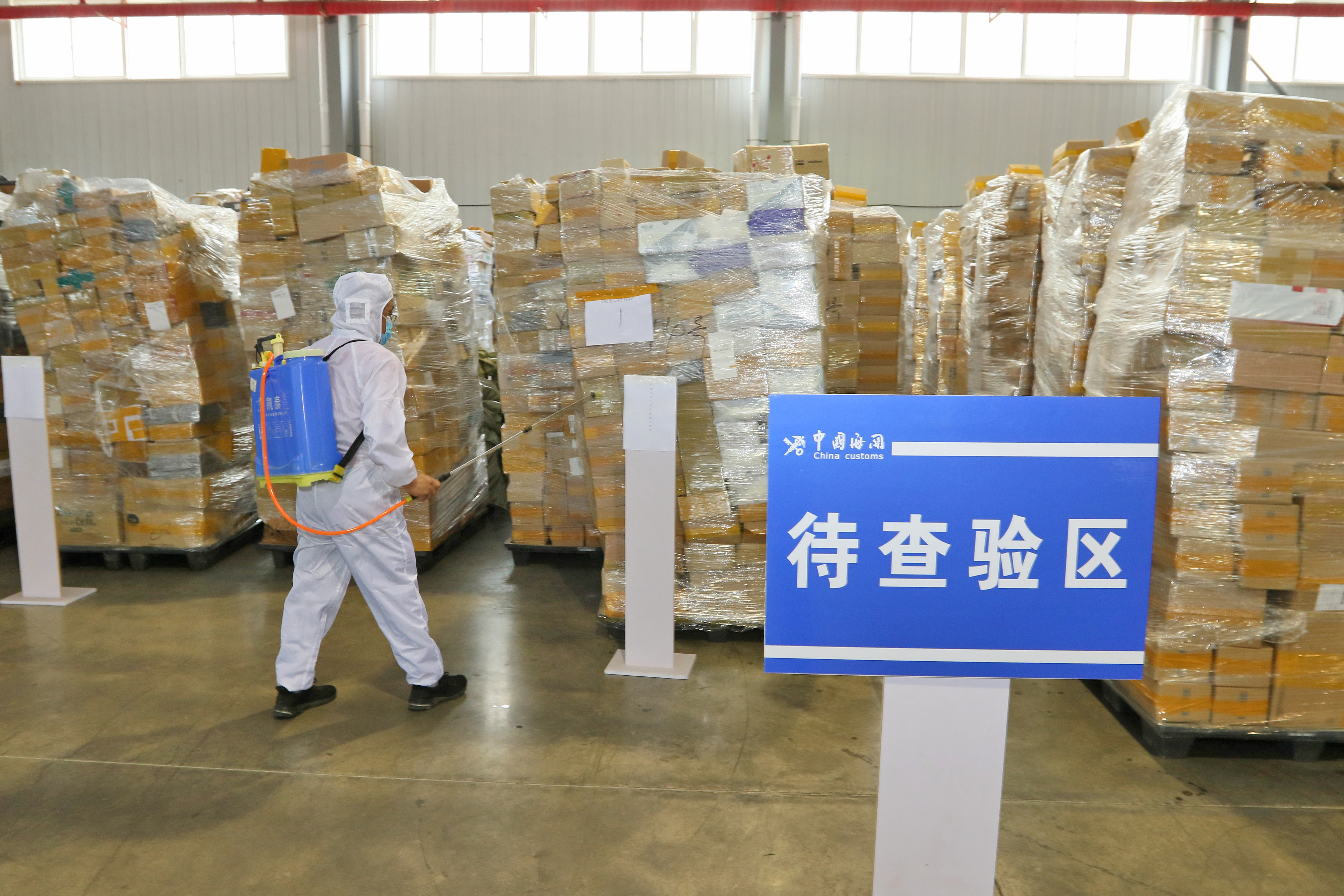 A worker disinfects cross-border express packages in Yantai, East China’s Shandong province, in August 2020. Photo: VCG