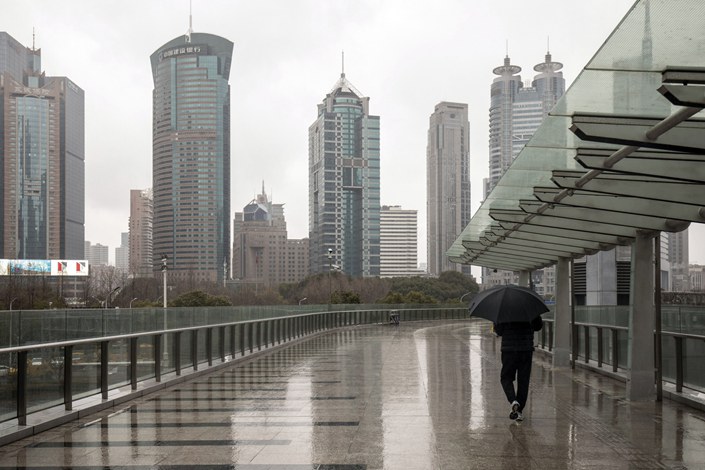 A pedestrian walks through the Lujiazui Financial District in Shanghai on Monday. Photo: Bloomberg
