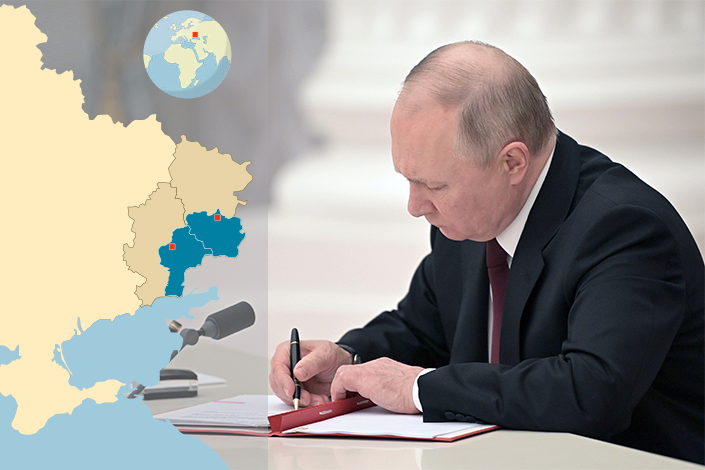 Russia’s President Vladimir Putin signs decrees to recognize the 