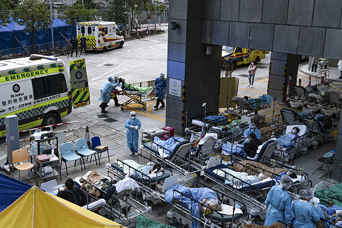 Covid-19 patients wait for medical treatment Wednesday outside a temporary holding area at Caritas Medical Center in Hong Kong. Photo: VCG