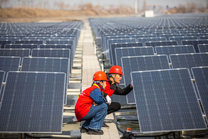 Technicians inspect a photovoltaic power station on Tuesday in East China’s Jiangsu province. Photo: VCG
