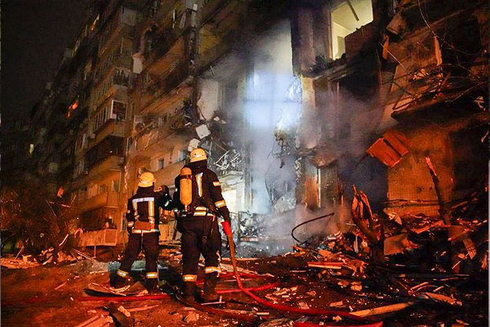 Firefighters inspect a damaged building following a rocket attack on the city of Kyiv, Ukraine, on Friday. Photo: VCG