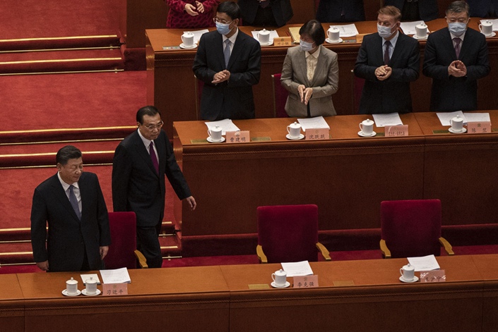 President Xi Jinping, left, prepares to take his seat as he arrives with Premier Li Keqiang at the Great Hall of the People on March 4, in Beijing. Photo: Bloomberg