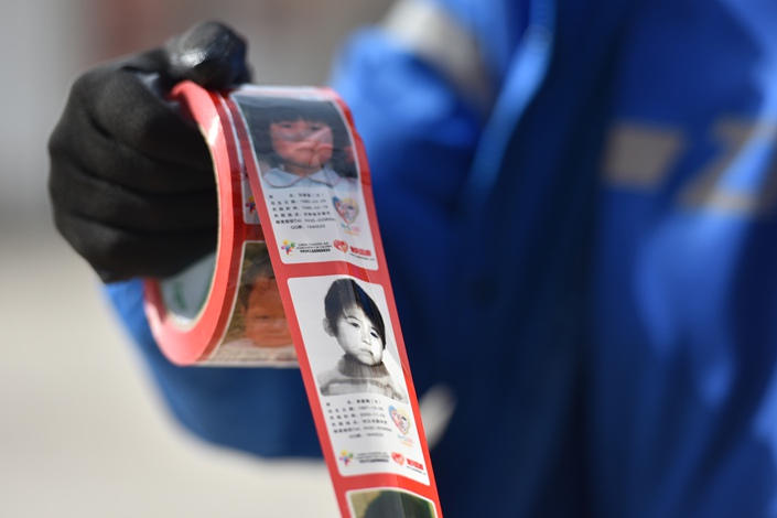 Customized tape printed with the photos and information of missing children used in express delivery outlets in Taiyuan, Shanxi province, on May 11, 2021. Photo: VCG
