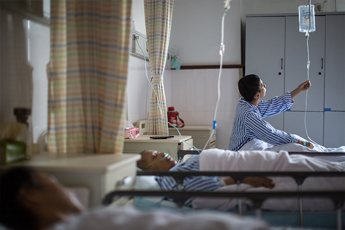 A breast cancer patient sits on a bed at a hospital in Hangzhou, East China’s Zhejiang province, in October 2019. Photo: VCG