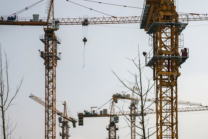 Cranes at a construction site for a residential development on the outskirts of Shanghai. Photo: Bloomberg