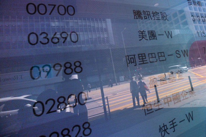 An electronic screen displays the stock codes for companies including Tencent, Meituan and Alibaba in Hong Kong, on March 15. Photo: Bloomberg