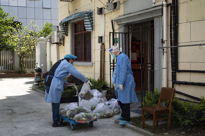 Volunteers deliver vegetables to residents in Shanghai under lockdown on Sunday. Photo: VCG