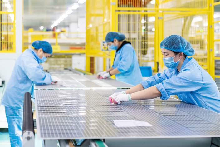 Workers make solar photovoltaic modules for export at a workshop of a new energy technology company in Nantong, Jiangsu province, on March 7. Photo: VCG