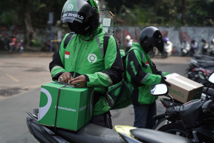 Gojek drivers pick up a PT Tokopedia order at a Titipaja fulfillment center in Jakarta on May 24. Photo: Bloomberg