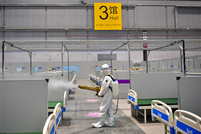 A medical worker disinfects a makeshift hosptial in Shanghai on Friday. Photo: IC Photo
