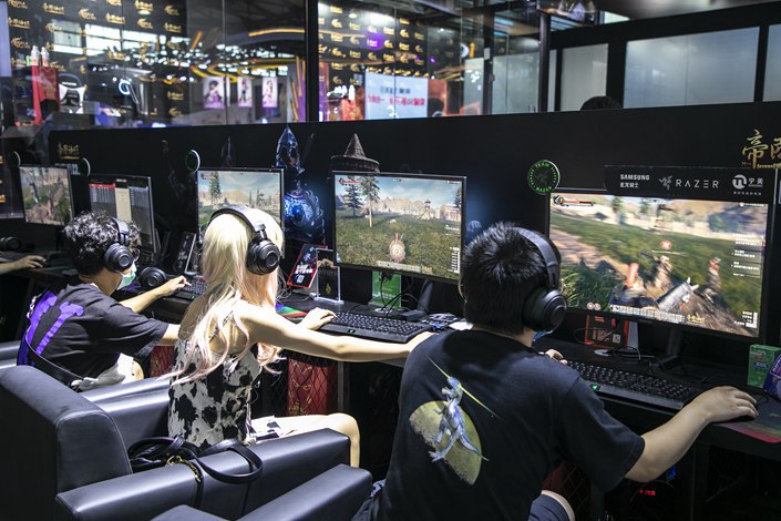 Visitors play video games at the China Digital Entertainment Exhibition in Shanghai on July 31, 2021. Photo: VCG