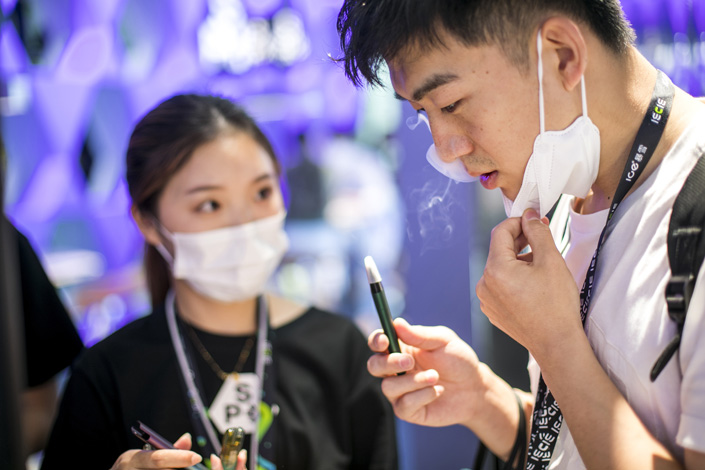 A man tries an e-cigarette in Shanghai in May 2021. Photo: VCG