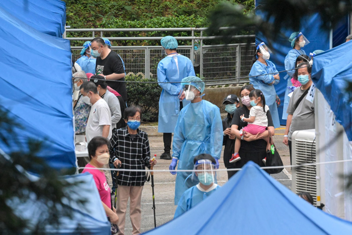 People line up for Covid-19 nucleic acid tests at Tsui Chuk Garden which is under restrictions to halt the spread of the coronavirus on April 13 in Hong Kong.  Photo: Bloomberg
