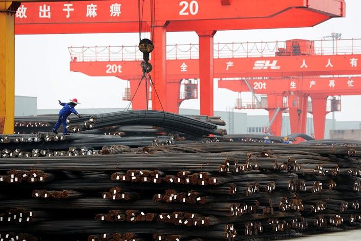 Workers load steel at a logistics park in Huzhou, Zhejiang province, Feb. 10, 2022. Photo: VCG