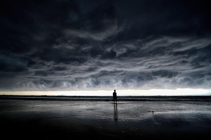 A man walks on the seaside before a cloud burst of rain in Udaipur, Digha, approximately 200 kilometers from Kolkata, on May 21. The India Meteorological Department (IMD) has predicted that the Monsoon rain will likely arrive a week early this year due to twin cyclones, Asani and Karim. Photo: VCG